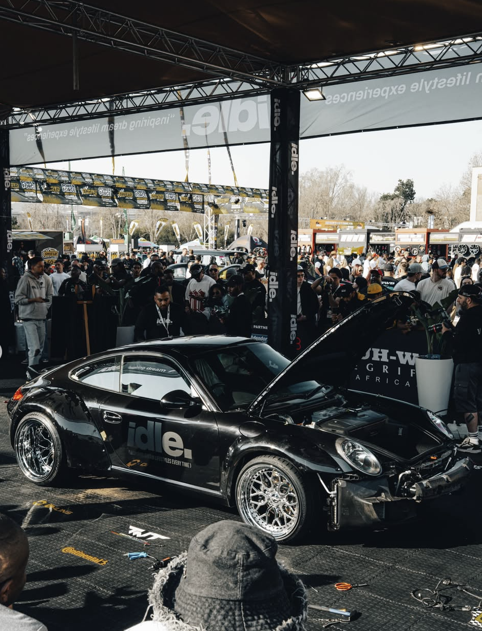 Kaizen mid-build in front of the JHB Idle Expo 2026 crowd, hood up, engine bay exposed